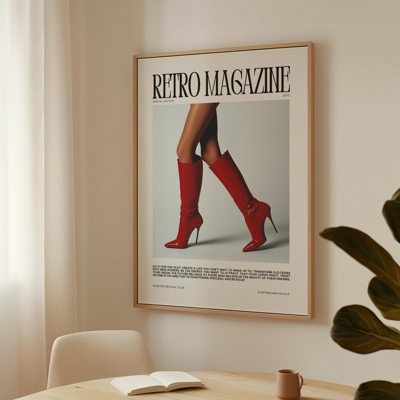 May include: A framed poster featuring the text "Retro Magazine" with a photograph of a person's legs wearing red high-heeled boots. The poster has a light wood frame and is hanging on a white wall.