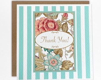 May include: A square greeting card featuring a light blue and white vertical striped background. The centre displays a rectangular frame filled with floral illustrations in shades of pink, teal, and brown, surrounding an oval with the text Thank You.