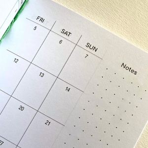 May include: A white paper planner page featuring a grid calendar layout with black text for the days FRI, SAT, and SUN, numbered dates 5 through 21, and a dedicated column on the right side labeled Notes with a black dot grid pattern.
