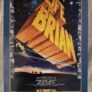 May include: A collectible 12-inch figure of Mandy from the movie Monty Python's Life of Brian. The figure is packaged in a box with a blue background and a picture of the movie's title card. The box also includes a warning about choking hazards for children under 3 years old.