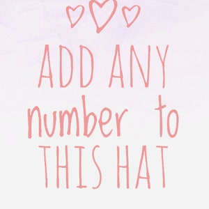 May include: Pink text on a light purple background with three pink hearts at the top. The text reads "ADD ANY number to THIS HAT".