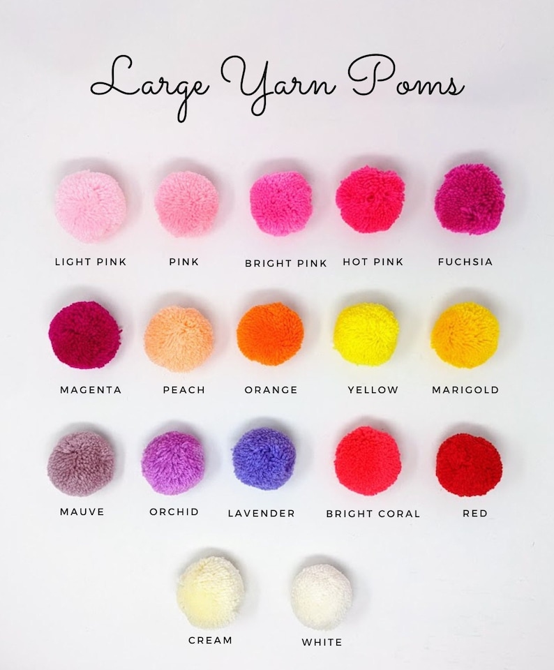 May include: A collection of large yarn pom-poms in various colors, including light pink, pink, bright pink, hot pink, fuchsia, magenta, peach, orange, yellow, marigold, mauve, orchid, lavender, bright coral, red, cream, and white.