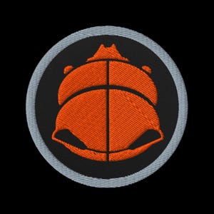 May include: Embroidered patch featuring an orange stylized insect design on a black background. The insect is enclosed within a circular patch with a light gray border. The patch is likely for clothing or accessories.