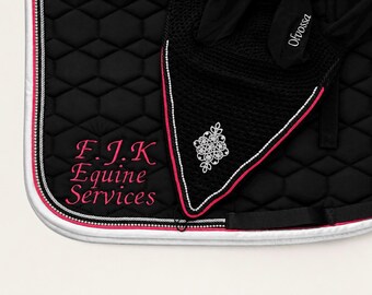 May include: A black quilted saddle pad and matching ear bonnet with pink and white trim. The saddle pad features the embroidered text F.J.K Equine Services in pink, while the ear bonnet displays a white floral emblem and the text Ofvossa.
