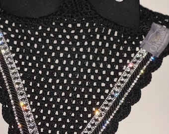 May include: A black crochet horse ear bonnet featuring two solid black ear covers with the white text Olvossa printed on one side. The front panel is decorated with a V-shaped border of clear crystals and a twisted black rope trim edge.