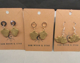 Gold-colored dangle earrings featuring an imprinted design