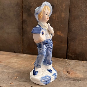 Vintage blue and white figurine boy with birdhouse