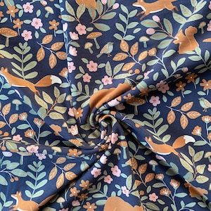 Jersey di cotone blu scuro con animali della foresta, tessuto per bambini