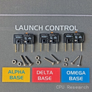 May include: Three black electrical switches labeled "OMRON 5A250V~" with the text "MADE IN INDONESIA" and "5E4 T85" on each switch. The switches are arranged in a row with the text "LAUNCH CONTROL" above them. Below the switches are three labels: "ALPHA BASE", "DELTA BASE", and "OMEGA BASE".