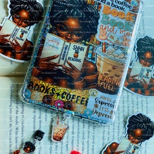 May include: A selection of stickers and charms with a bookish theme. The stickers depict women reading, coffee cups, donuts, and phrases such as "Reading Fuel" and "Books + Coffee."