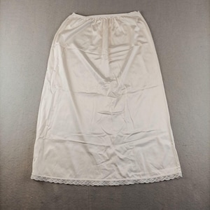 May include: A white slip skirt with a lace trim. The skirt is made of a silky material and has a simple, classic design.