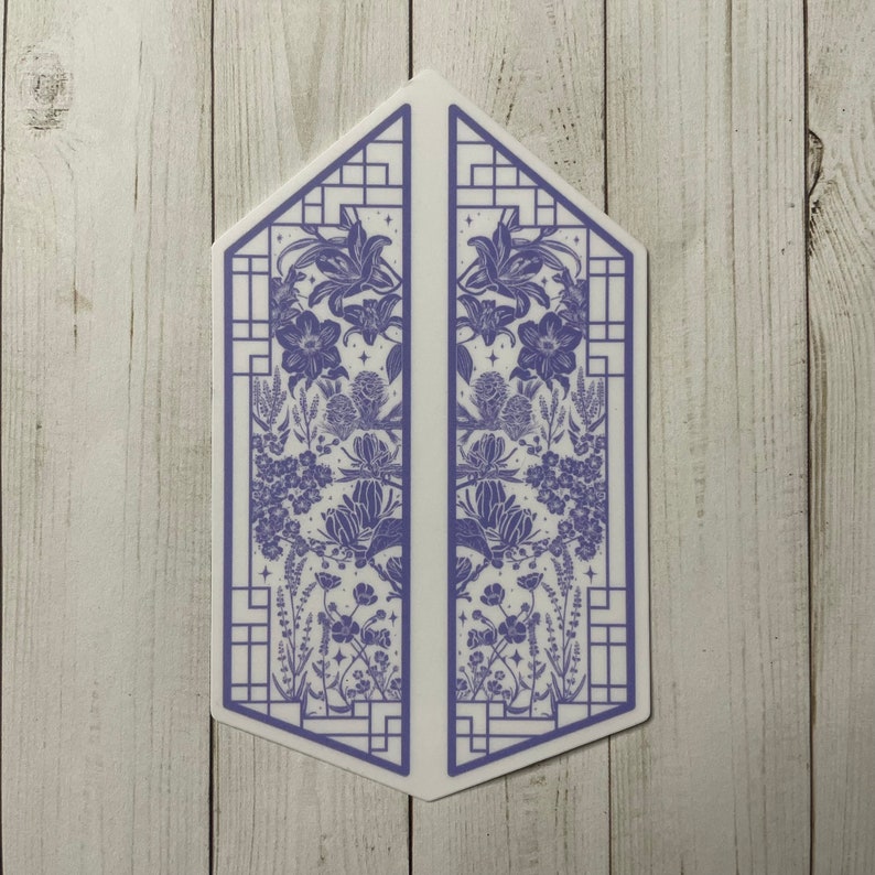 May include: A symmetrical design of a blue floral pattern inside a white frame with a geometric pattern. The design is split into two halves, with each half featuring a different arrangement of flowers and leaves. The design is reminiscent of a window or a door.