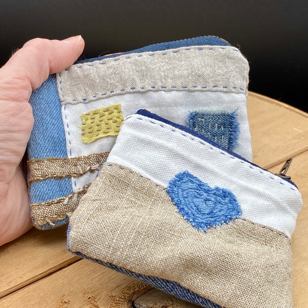 Small zippered coin purse hand stitched from recycled fabrics and denim