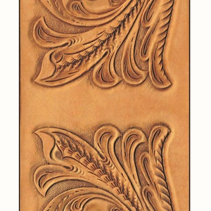 May include: Two brown leather panels with intricate floral designs carved into the surface. The designs are symmetrical and feature a central swirl with flowing lines and leaves.