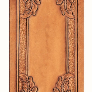 May include: A brown leather panel with a decorative border of oak leaves. The border is embossed with a raised design. The panel is blank and ready for personalisation.