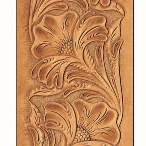 May include: A close-up of a brown leather panel with a tooled design of three stylised flowers. The flowers have a raised, textured design and are arranged vertically.