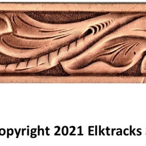 May include: A close-up of a brown leather strip with a carved floral design. The design features two stylized flowers with leaves and stems. The text "Copyright 2021 Elktracks Studio" is visible at the bottom of the image.