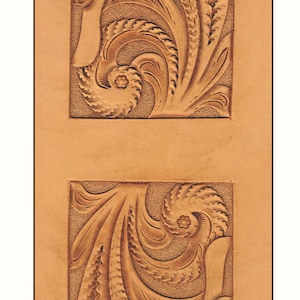 May include: Two leather panels with intricate floral designs carved into the surface. The designs are symmetrical and feature swirling patterns.