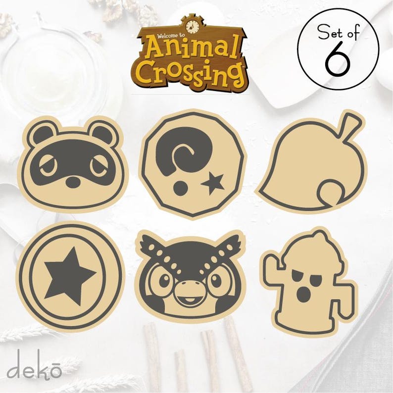 May include: Set of six Animal Crossing themed wooden cutouts. The cutouts feature characters and symbols from the popular video game series. The cutouts are beige and feature black and gray details. The cutouts include a raccoon, a leaf, a star, an owl, a fire hydrant, and a spiral.