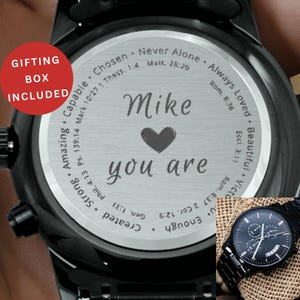 May include: Black wristwatch with a personalized engraving on the watch face. The engraving includes the name "Mike", a heart symbol, and the words "you are". The watch has a black metal band and a small subdial.