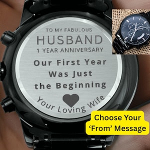 May include: Black wristwatch with a stainless steel face engraved with a message for a husband on their 1-year anniversary. The message reads "To My Fabulous Husband, Our First Year Was Just the Beginning, Your Loving Wife."