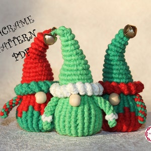 May include: Three macrame gnomes with green and red hats, white trim, and wooden noses. The gnomes are made with a macrame technique and have a bell on top of their hats. The image includes the text "MACRAME PATTERN PDF".
