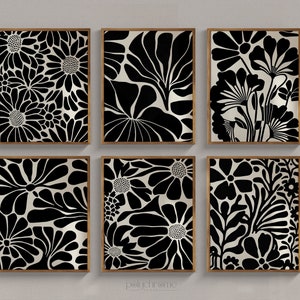 May include: Set of six black and white floral print wall art prints in wooden frames. The prints feature a variety of floral patterns, including daisies, leaves, and other abstract shapes.