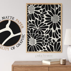 May include: Black and white floral print art print with a thick matte paper texture. The print is framed in a natural wood frame. The text "polychrome pages" is visible below the print.
