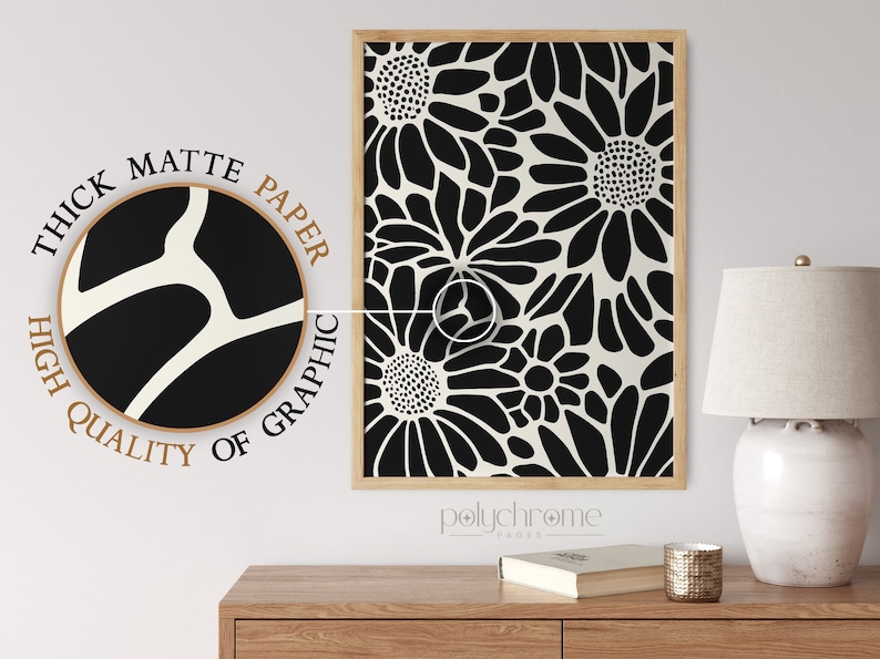 May include: Black and white floral print art print with a thick matte paper texture. The print is framed in a natural wood frame. The text "polychrome pages" is visible below the print.