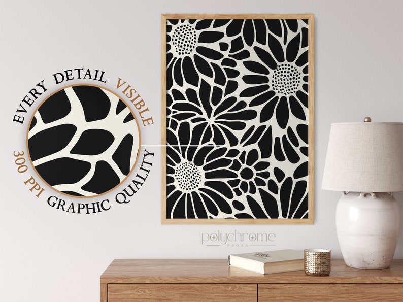May include: A black and white floral print art print with a wood frame. The print is of stylized flowers with a white background. The print is labeled "polychrome pages".