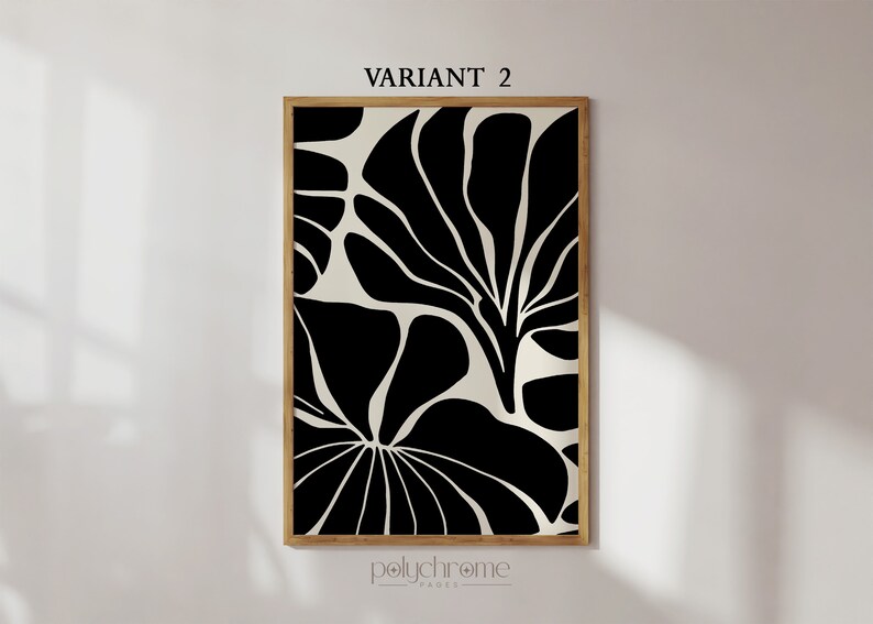 May include: Black and white abstract art print with a floral design. The print is framed in a natural wood frame. The print is titled "VARIANT 2" and is by the brand "polychrome_paper".