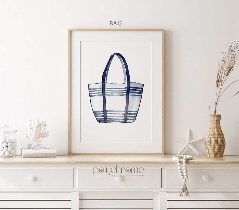 May include: A watercolor illustration of a blue and white striped tote bag. The bag is hanging from its handles and has a white background with blue stripes. The image is framed and has the text "BAG" at the top and "polychrome pages" at the bottom.