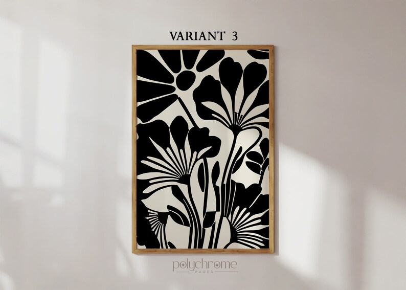 May include: Black and white abstract floral print art in a wooden frame. The print features stylized flowers with large petals and stems.