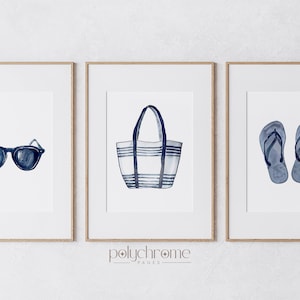 May include: Three framed watercolor illustrations of summer essentials: a pair of sunglasses, a striped tote bag, and a pair of flip flops. All items are in shades of blue.