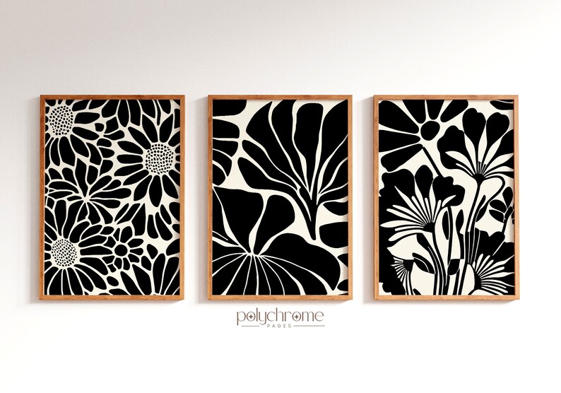 May include: Three framed black and white floral prints with a cream background. The prints are arranged in a row on a white wall.