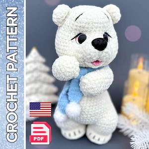 May include: A white crochet bear with a blue scarf, black eyes, and a pink mouth. The bear is holding its arms in front of itself. The image also includes the text "CROCHET PATTERN" and a PDF icon.