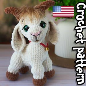 May include: A cream-coloured crocheted goat plush toy with brown horns and hooves, large green eyes, and a small pink nose. The goat wears a thin red collar with a small gold bell. The text "Crochet pattern" and a US flag icon are visible.