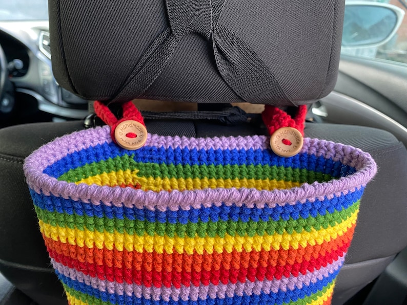 May include: A rainbow crocheted car seat organizer with two wooden buttons that say "Handmade with Love".