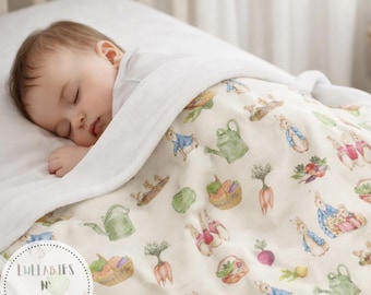 May include: A sleeping baby is nestled under a soft, white blanket. The blanket features a whimsical pattern of rabbits, watering cans, and vegetables in shades of green, blue, and orange. The blanket has the text "Lullabies N' Lollies" in a circle.