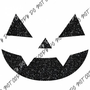 May include: Black glitter pumpkin face with a wide smile and two triangle eyes.