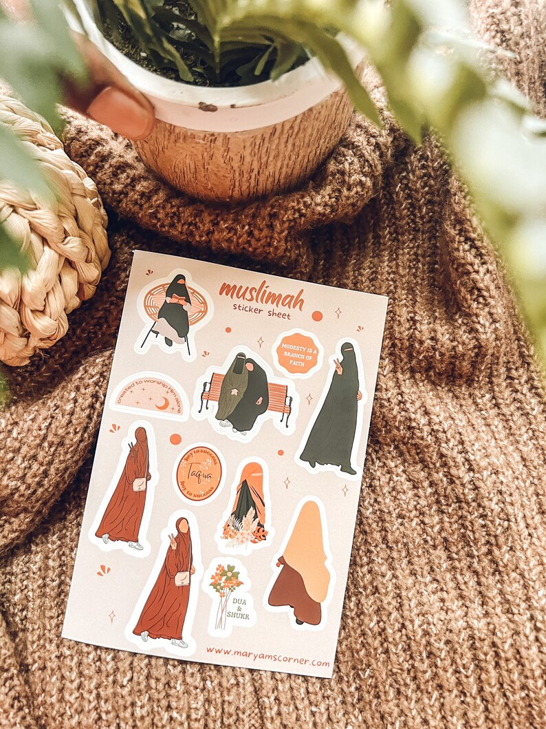 May include: A sticker sheet with illustrations of women wearing hijabs. The sheet includes the text "muslimah sticker sheet", "MODESTY IS A BRANCH OF FAITH", "taqwa", and "DUA & SHUKR".