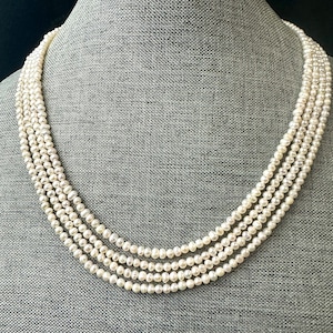 Freshwater pearl multi strand necklace. 4-5mm  baroque pearls with gold/silver clasps.
