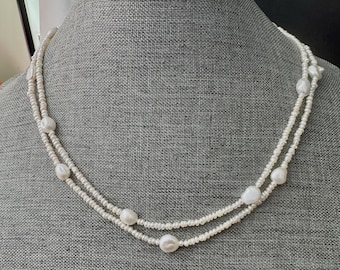 Freshwater station necklace. Small genuine tiny pearls (3mm) and large baroque pearls(7-8). Can be wear one strand or 2 layers.