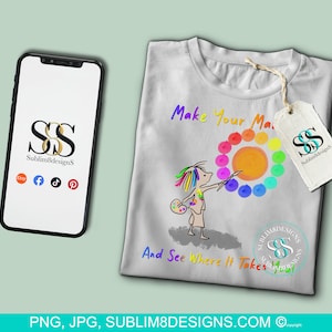 May include: A white t-shirt with the text "Make Your Mark" and "And See Where It Takes You" in black. A colorful rainbow color wheel with a cartoon person holding a paintbrush is in the center of the shirt. The text "Sublim8Designs" is in a gold circle on the bottom right of the shirt.