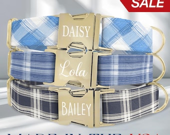 May include: Three personalized dog collars with plaid patterns in blue and white, and navy and white. Each collar has a gold-colored buckle engraved with a dog's name: Daisy, Lola, and Bailey. The collars are labeled "MADE IN THE USA."
