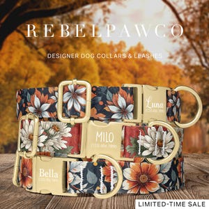 May include: Three designer dog collars with floral patterns in navy, orange, and white. Each collar has a gold-colored buckle and a name engraved on it: Bella, Milo, and Luna. The collars are displayed on a wooden surface.