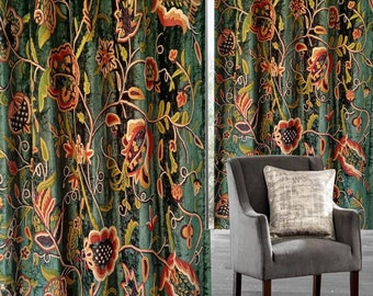 May include: A pair of green velvet curtains with a floral pattern. The curtains have a dark green background with orange, yellow, and black flowers. The curtains are hung on a window with a chair in front of them.