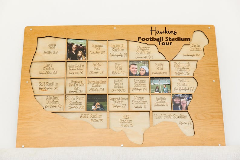 May include: Wooden map-shaped display with cutouts for photos, labeled "Hawkins Football Stadium Tour." Includes stadium names and photos, with a light wood finish. A unique piece for sports fans.