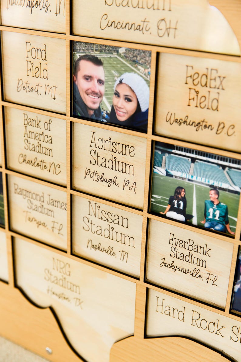 May include: Wooden wall art featuring stadium names and photos. Includes Ford Field, Acrisure Stadium, and EverBank Stadium. Photos of people are in some of the squares. The names of the stadiums are in a handwritten font.