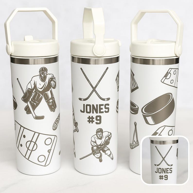 May include: White insulated water bottle with a handle, featuring hockey-themed graphics. The design includes hockey players, crossed hockey sticks, pucks, and the name "JONES #9". The bottle has a white lid and a silver band.